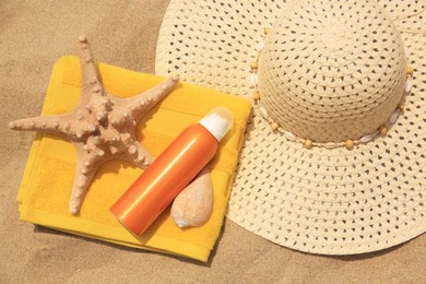 Flat lay composition with sunscreen on sand. Sun protection care