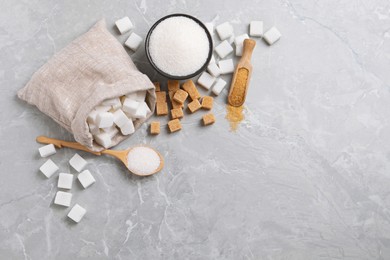 Photo of White and brown sugar on light grey marble table, flat lay. Space for text