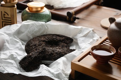 Aromatic pu-erh on wooden table. Fermented tea