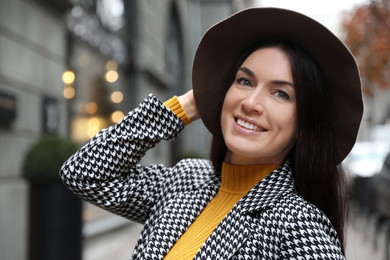 Photo of Portrait of beautiful woman in stylish suit on city street