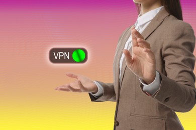 Woman and switched on VPN button on color background, closeup