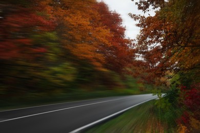Asphalt country road in autumn, motion blur effect