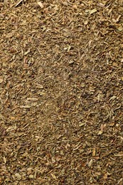 Photo of Aromatic dried basil as background, top view