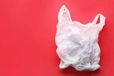 Photo of Clear disposable plastic bag on color background. Space for text