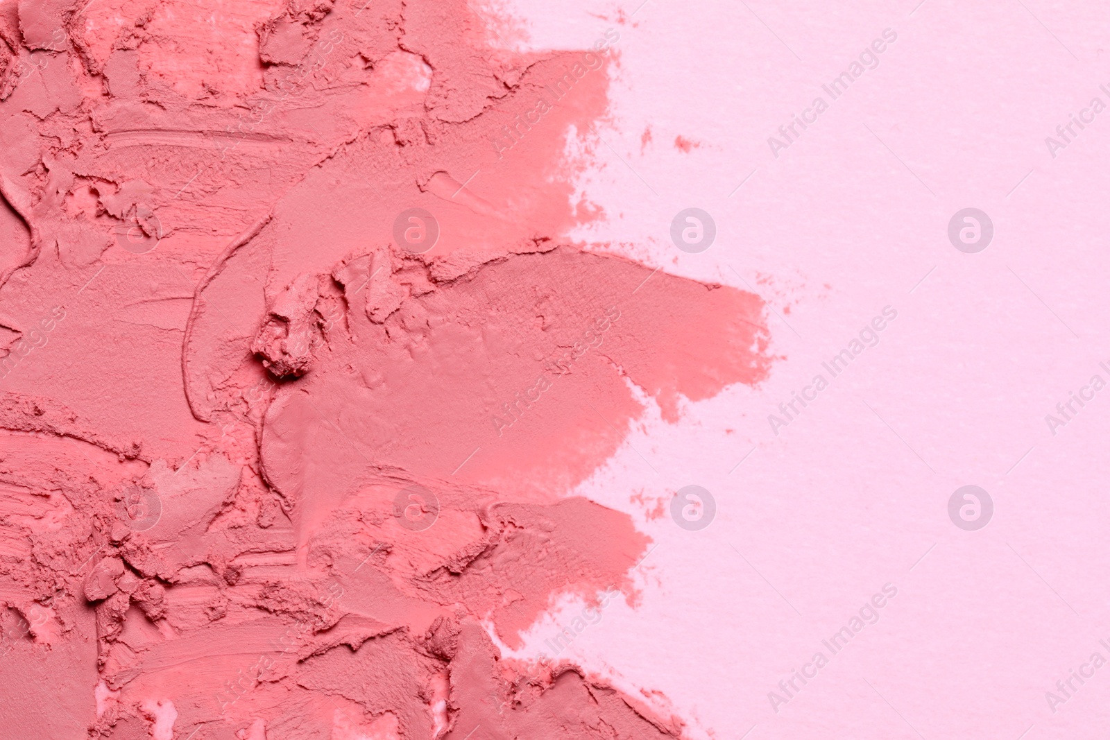 Photo of Smears of beautiful lipstick on pink background, top view. Space for text