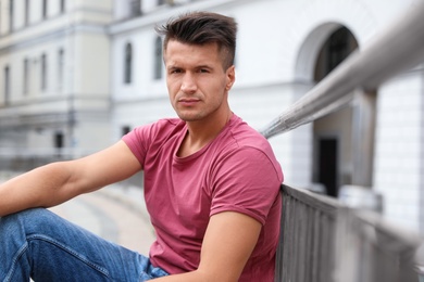 Portrait of handsome young man on city street