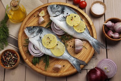 Photo of Flat lay composition with raw dorado fish on wooden table