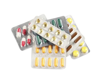 Blisters with different pills on white background, above view