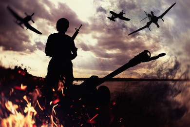 Image of Soldier with weapon and planes in combat zone. Military service