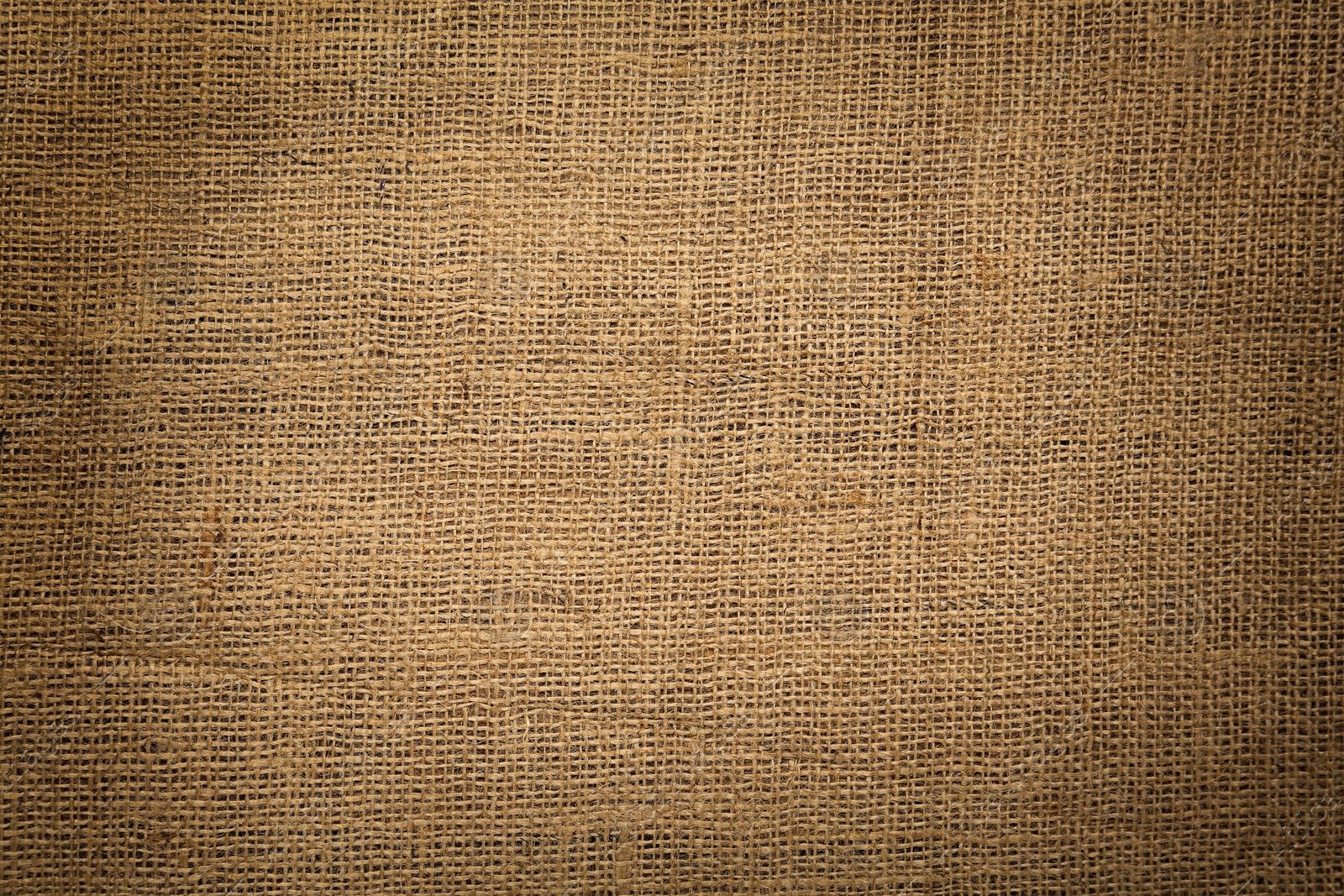 Image of Texture of natural burlap fabric as background, top view. Vignette effect 