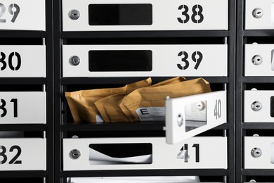 Photo of Open mailbox with keyhole, number and envelopes