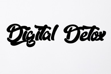 Photo of Phrase DIGITAL DETOX written on paper, closeup
