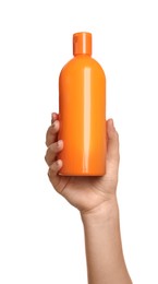 Photo of Woman holding plastic bottle of cosmetic product on white background, closeup