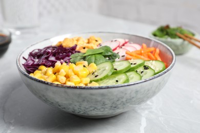 Delicious salad with chicken, vegetables and spinach on grey marble table, closeup