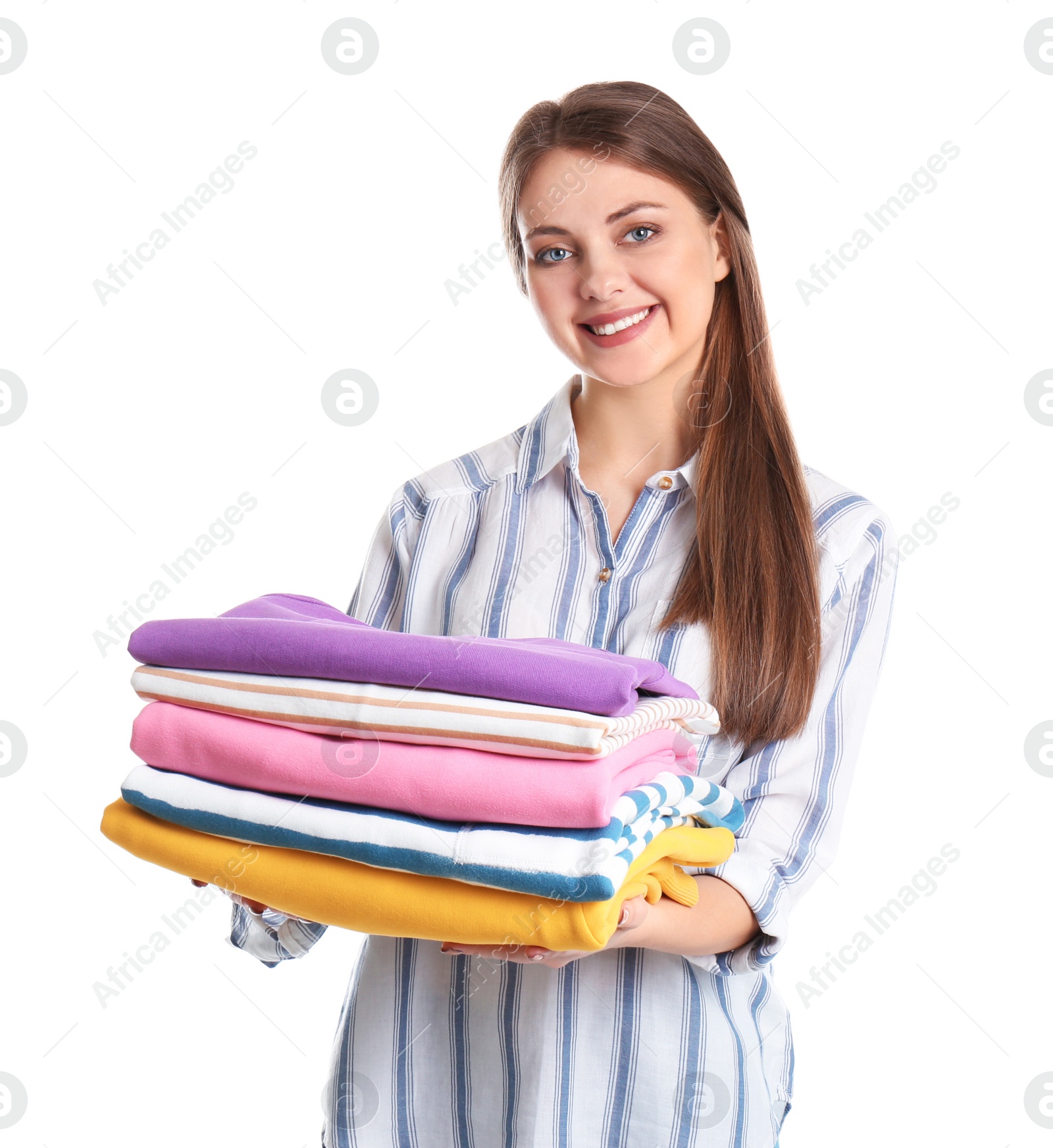Photo of Happy young woman holding clean towels on white background. Laundry day