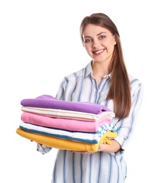 Happy young woman holding clean towels on white background. Laundry day