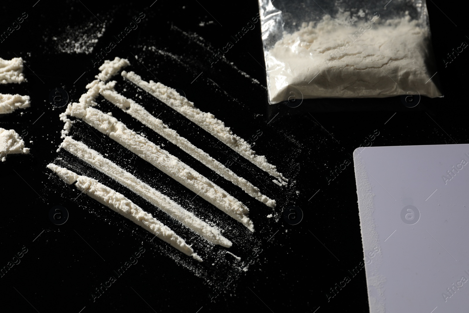 Photo of Drug addiction. Cocaine and blank card on black background,, flat lay