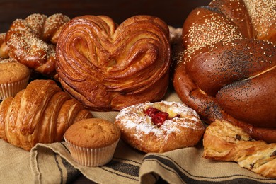 Photo of Different tasty freshly baked pastries on table