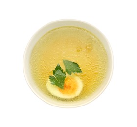 Delicious chicken bouillon with egg and parsley in bowl on white background, top view