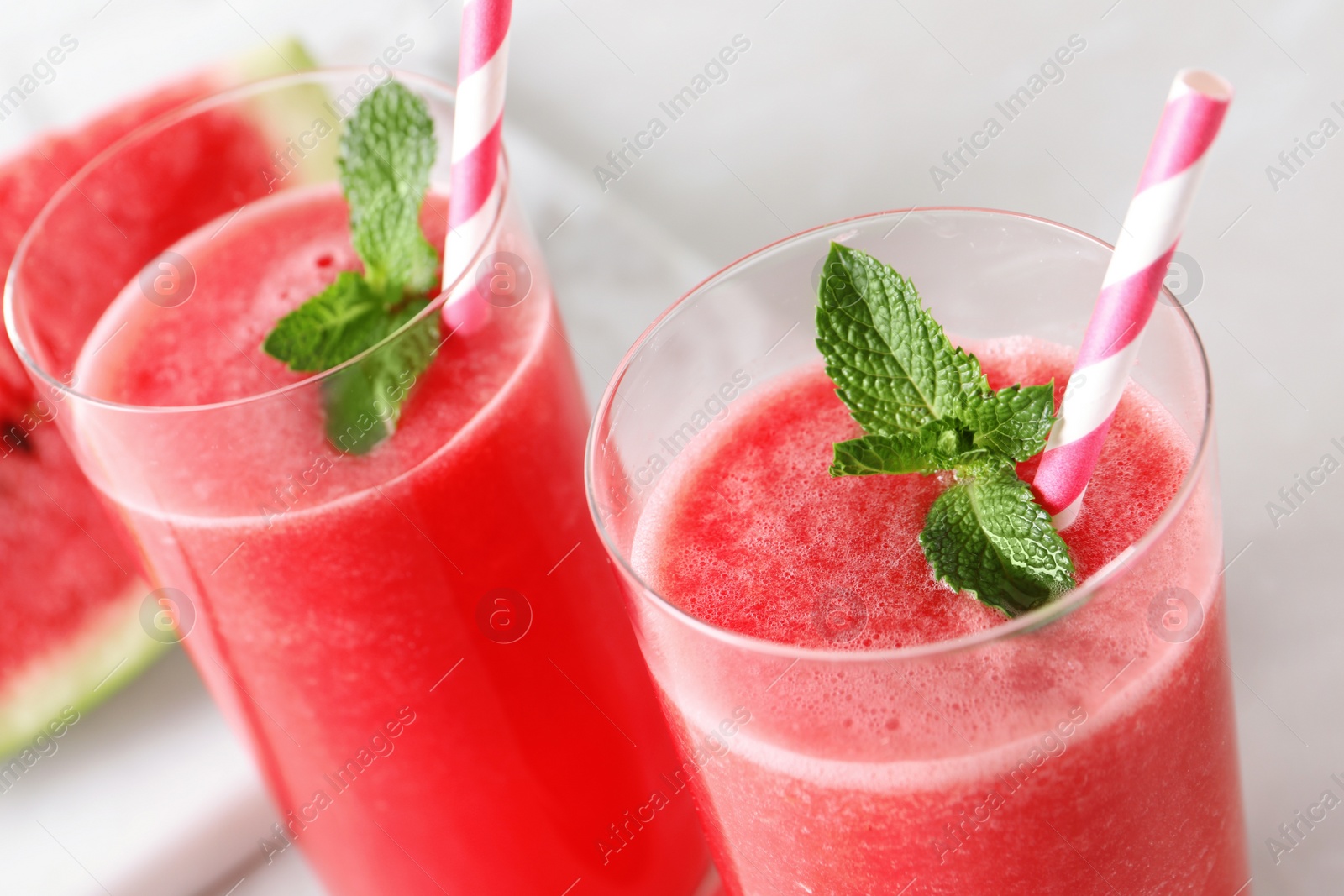 Photo of Tasty summer watermelon drink with mint in glasses, closeup