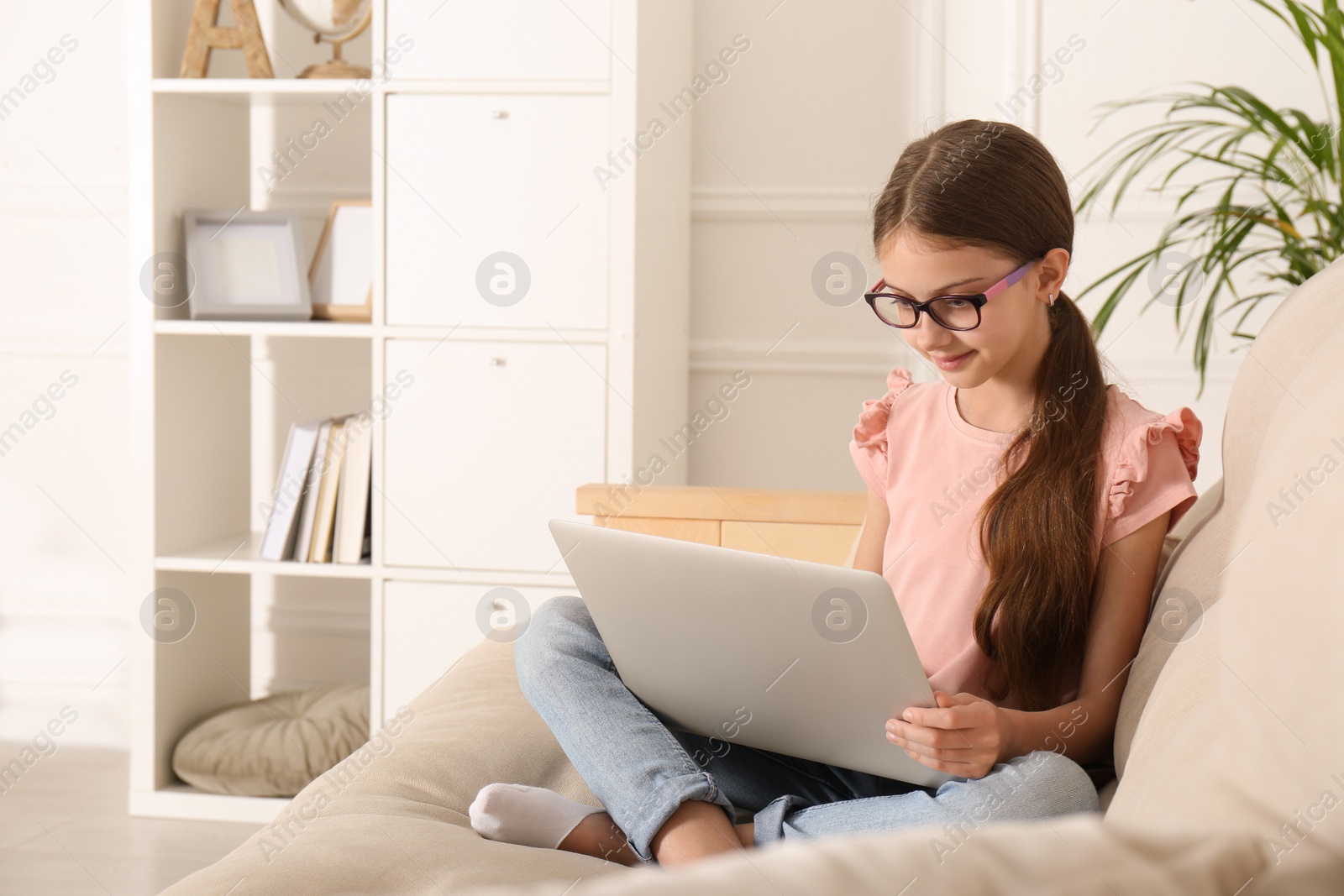 Photo of Girl with laptop on sofa at home