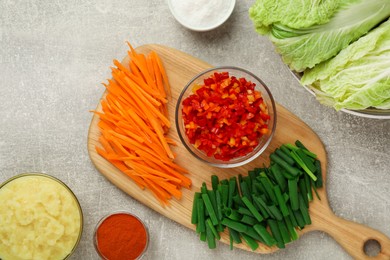 Photo of Fresh Chinese cabbages and other ingredients for kimchi on light grey table, flat lay