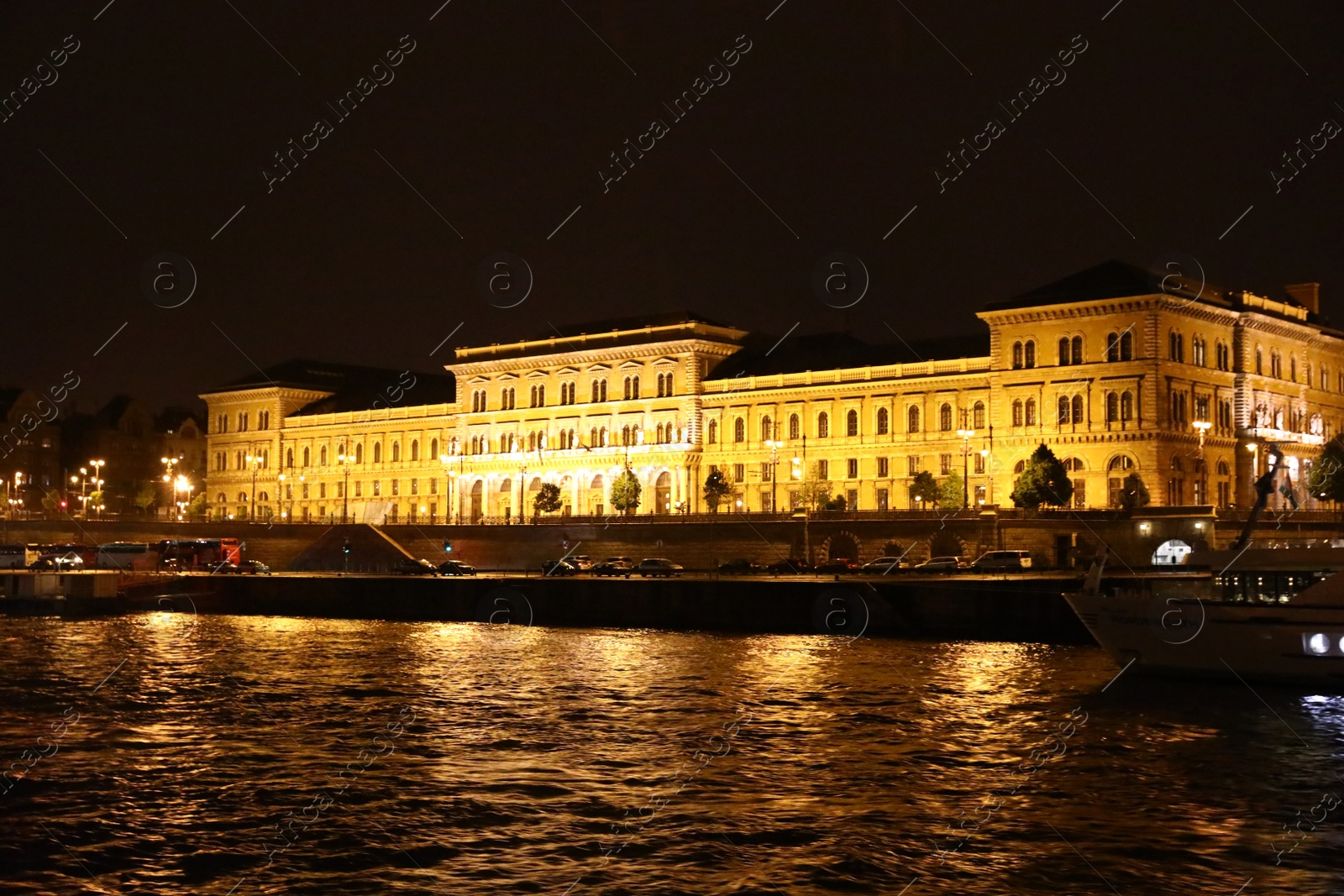 Photo of BUDAPEST, HUNGARY - APRIL 27, 2019: Beautiful night cityscape with illuminated Corvinus University