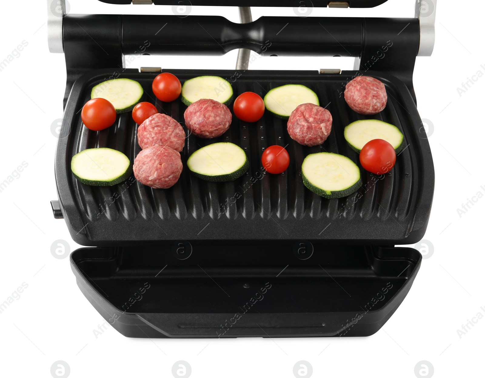 Photo of Electric grill with meat balls, zucchini and tomatoes isolated on white