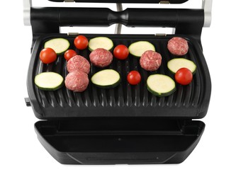 Electric grill with meat balls, zucchini and tomatoes isolated on white