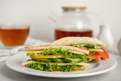 Photo of Delicious sandwiches with vegetables and cheese on table, closeup