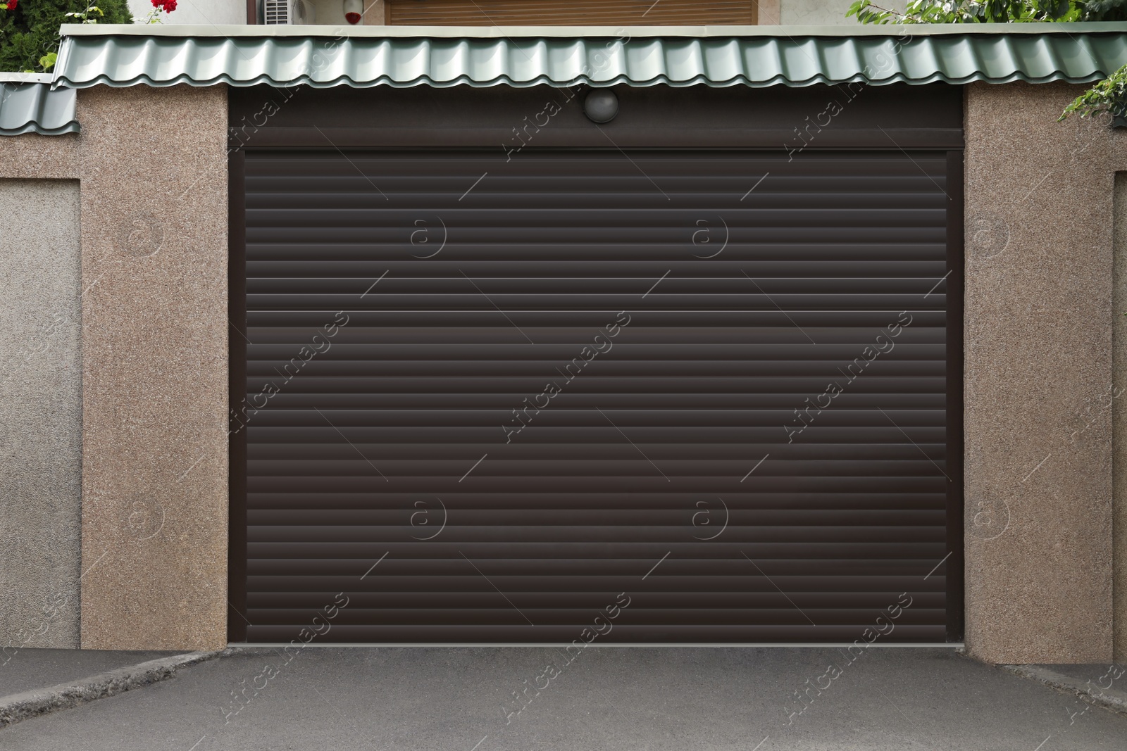 Photo of Building with brown roller shutter garage door