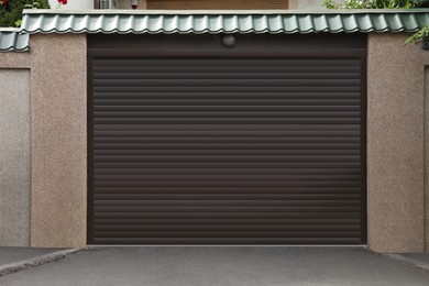 Photo of Building with brown roller shutter garage door