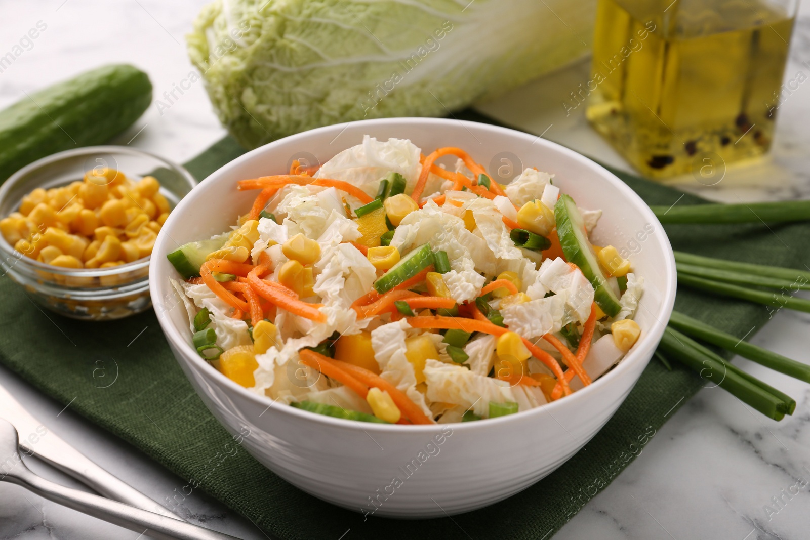 Photo of Tasty salad with Chinese cabbage served on white marble table, closeup