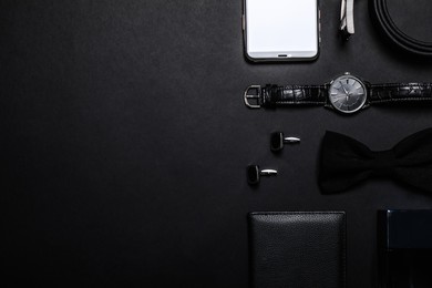 Flat lay composition with male accessories on black background, space for text