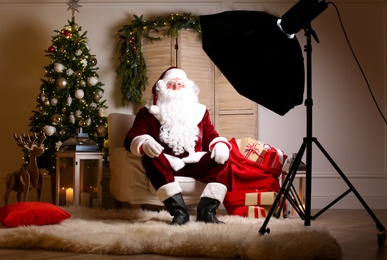 Santa Claus in photo zone decorated for Christmas