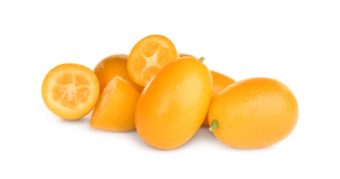 Photo of Whole and cut ripe kumquats on white background. Exotic fruit