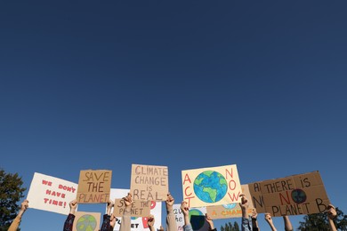 Group of people with posters protesting against climate change outdoors, closeup