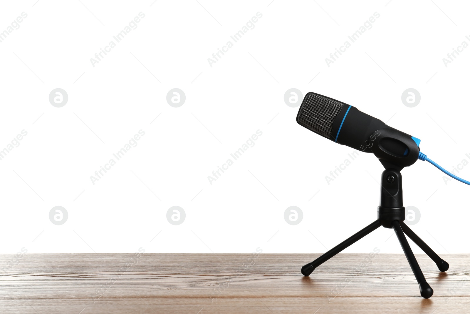 Photo of Microphone on table against white background. Space for text