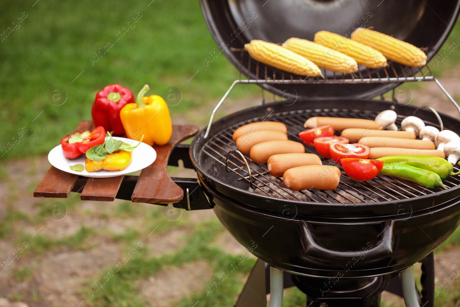 Photo of Barbecue grill with tasty fresh food outdoors