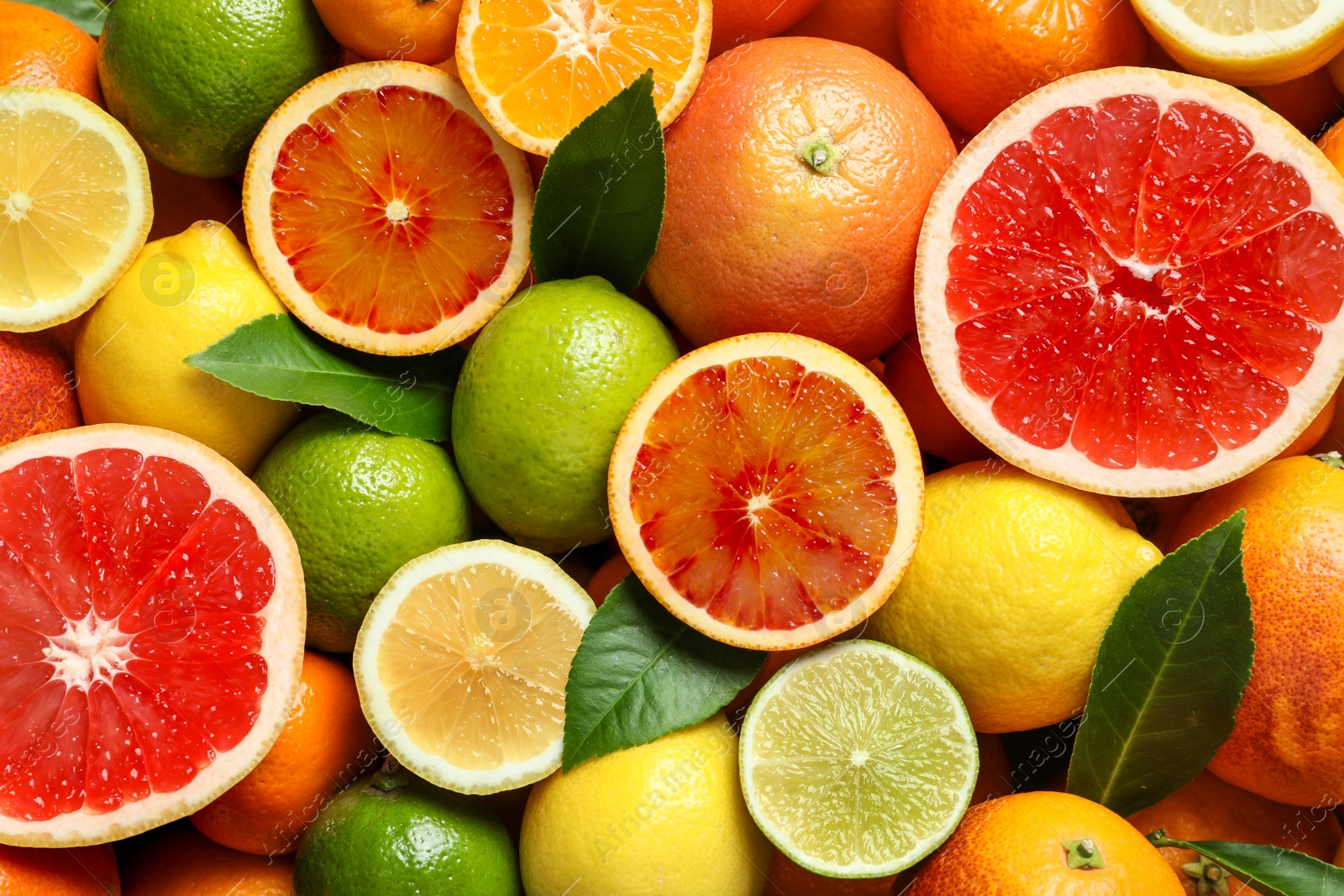 Photo of Different citrus fruits as background, top view