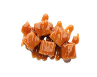 Photo of Caramel candies with topping on white background, top view