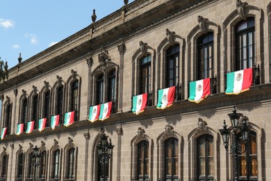 Photo of MONTERREY (NUEVO LEON), MEXICO - SEPTEMBER 29, 2022: Beautiful view of Palacio de Gobierno (Government Palace) with flags on sunny day