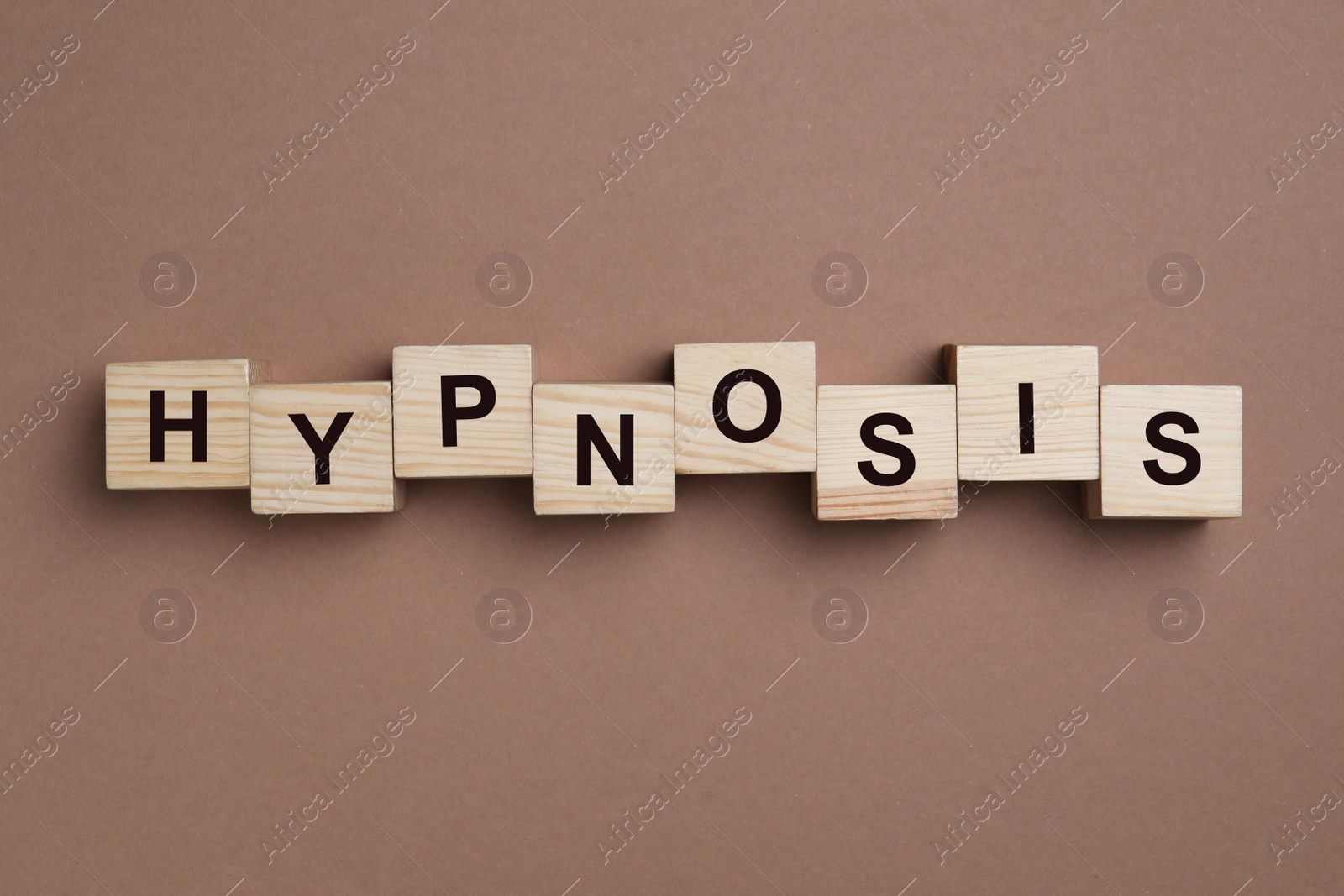 Photo of Wooden blocks with word HYPNOSIS on brown background, flat lay