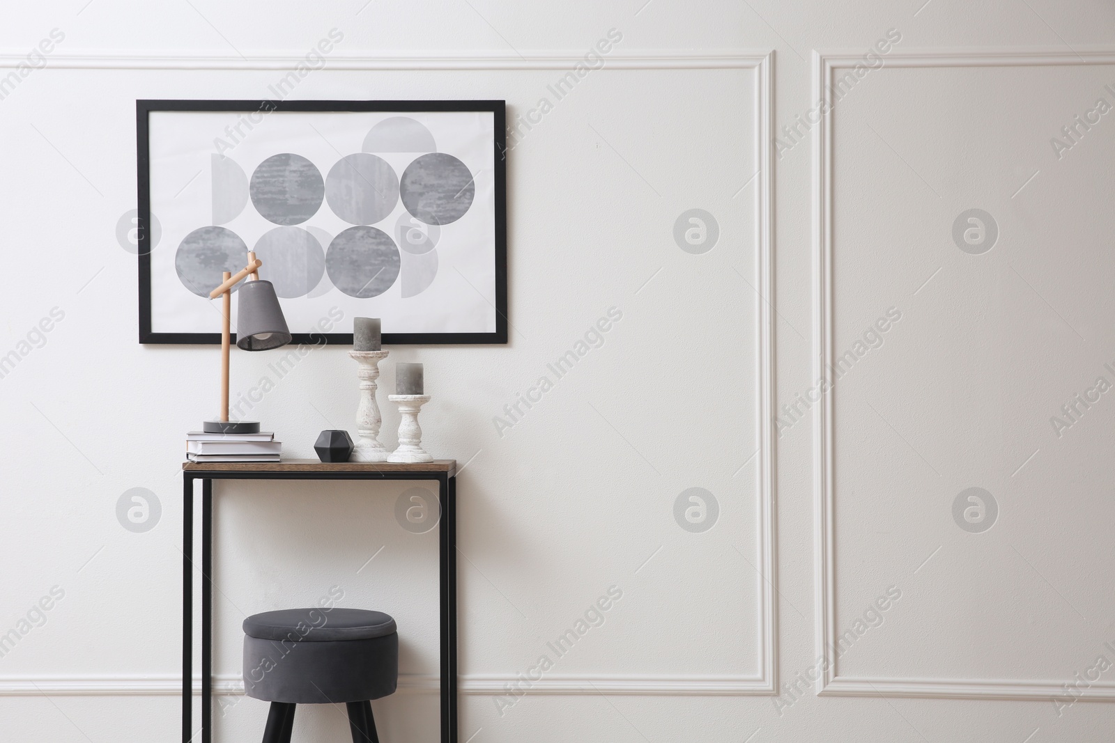 Photo of Hallway with stylish console table and picture. Interior design