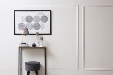 Hallway with stylish console table and picture. Interior design