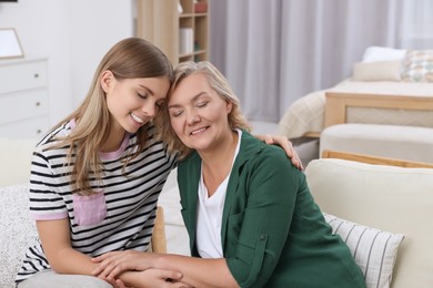 Photo of Young woman with her mom at home. Happy Mother's Day