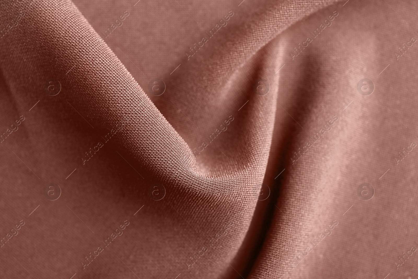 Image of Textured rose gold fabric as background, closeup view