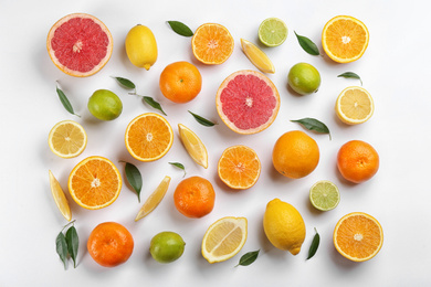 Photo of Flat lay composition with tangerines and different citrus fruits on white background