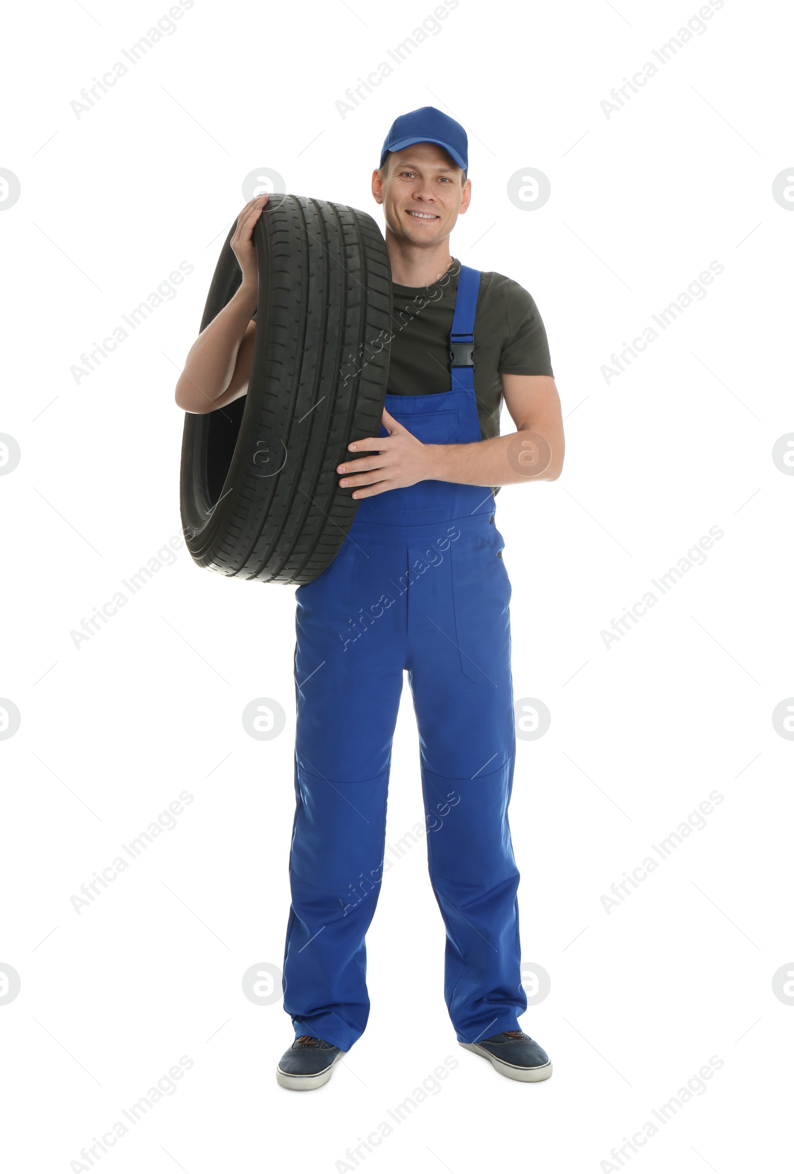 Photo of Full length portrait of professional auto mechanic with tire on white background