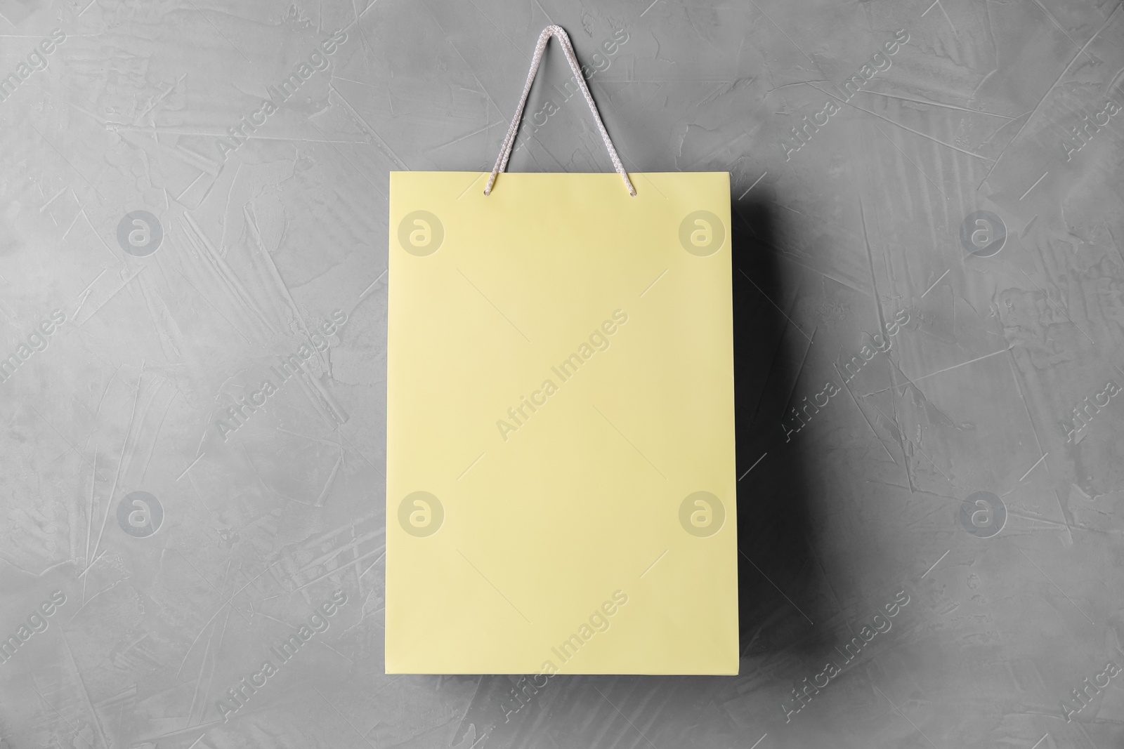 Photo of Paper shopping bag hanging on grey wall